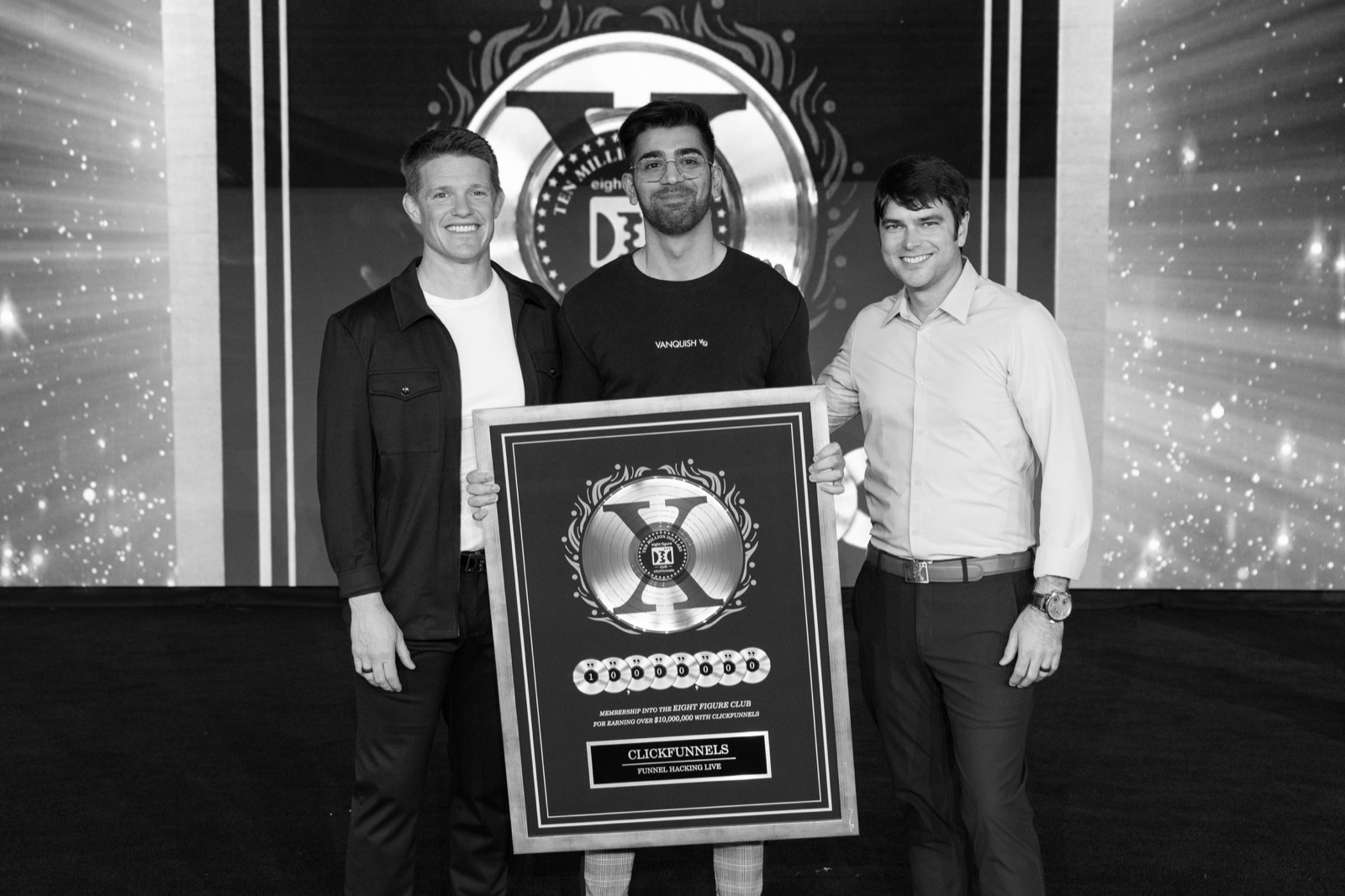 Sabby on stage at Funnel Hacking Live holding the ClickFunnels Eight Figure Club award for over $10,000,000 earned